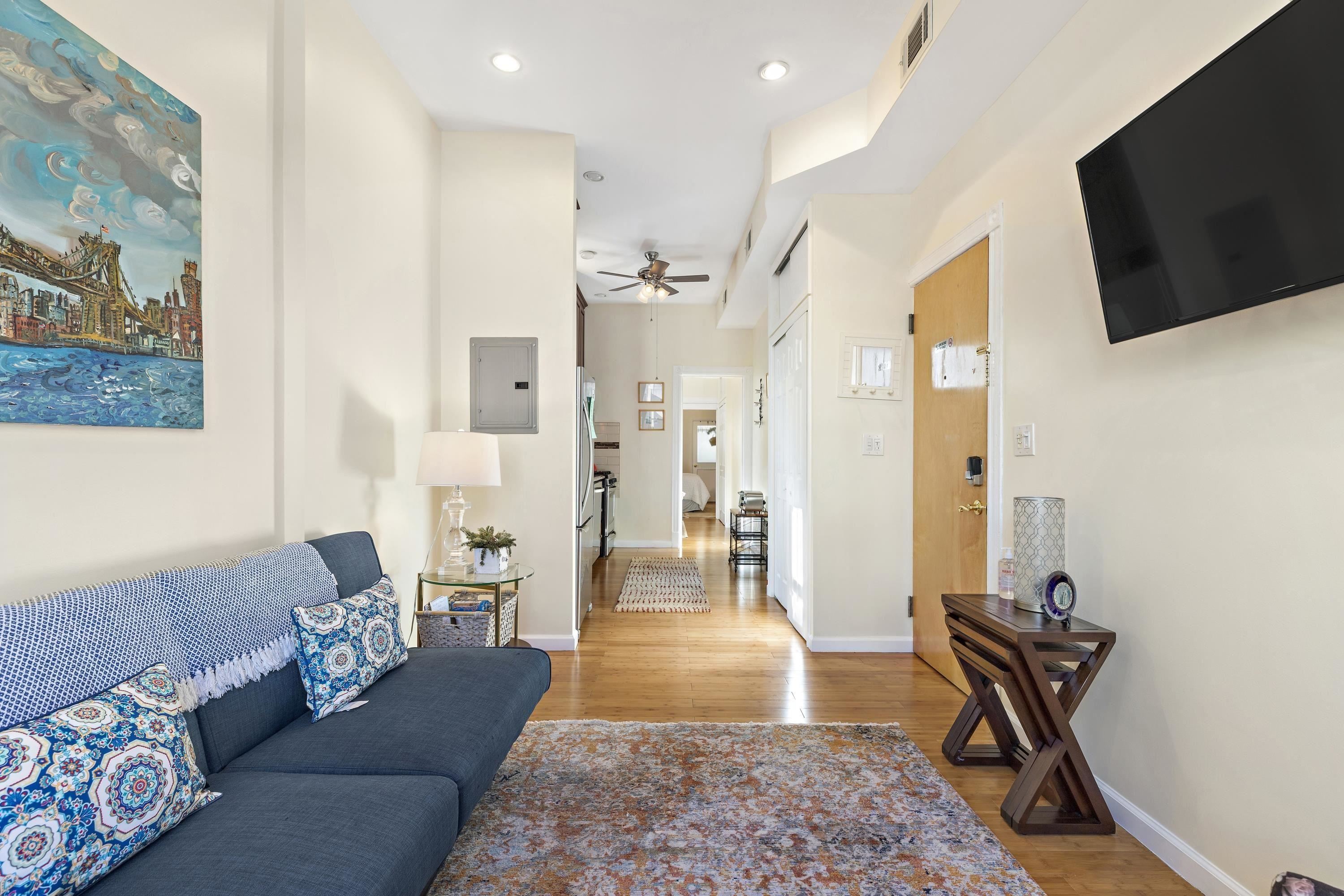 a living room with furniture rug and a flat screen tv