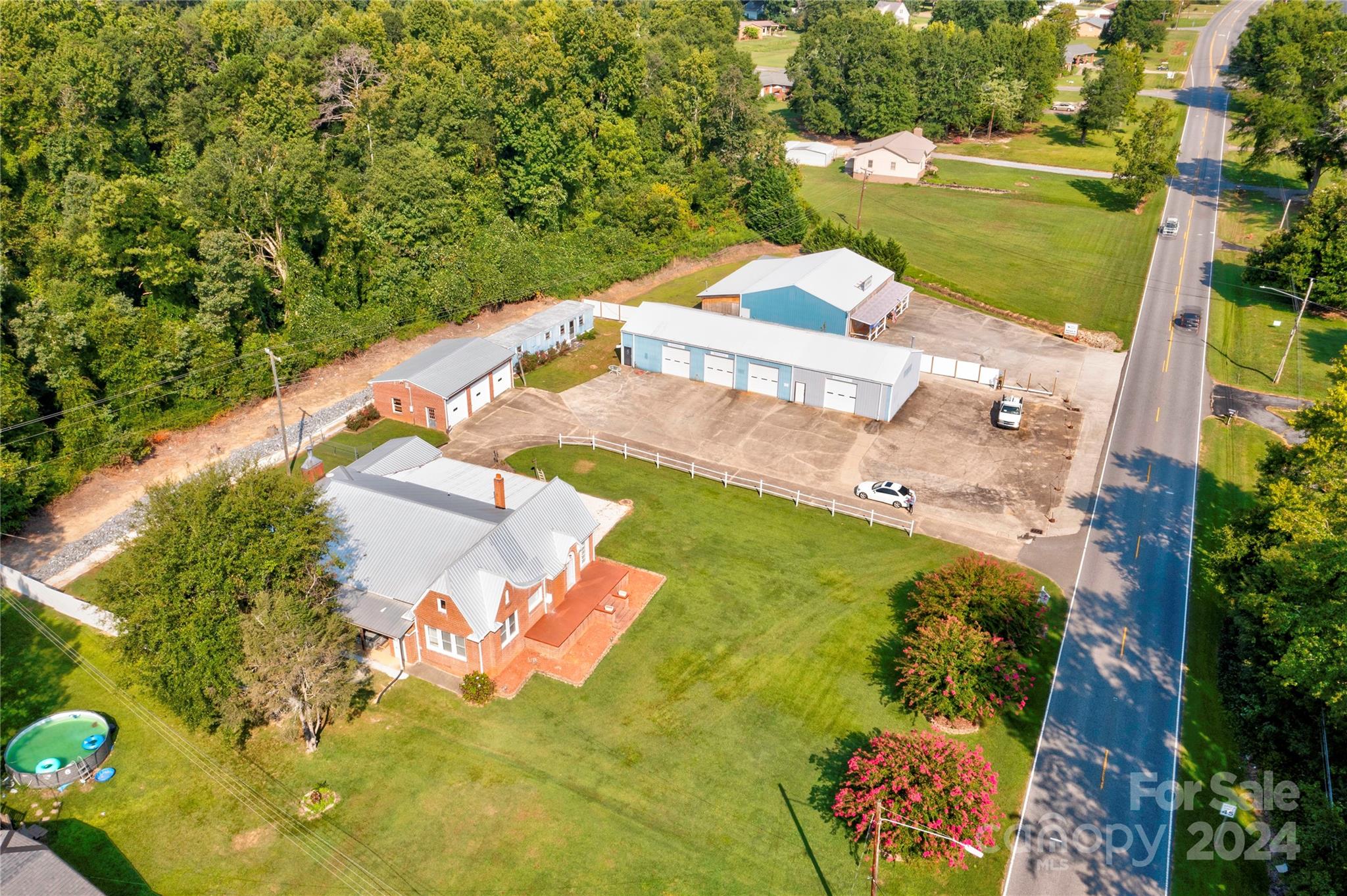 an aerial view of a house with a yard basket ball court and outdoor seating