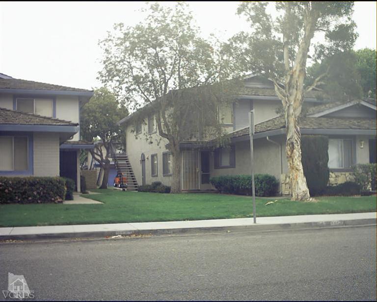 a view of a brick house with a yard