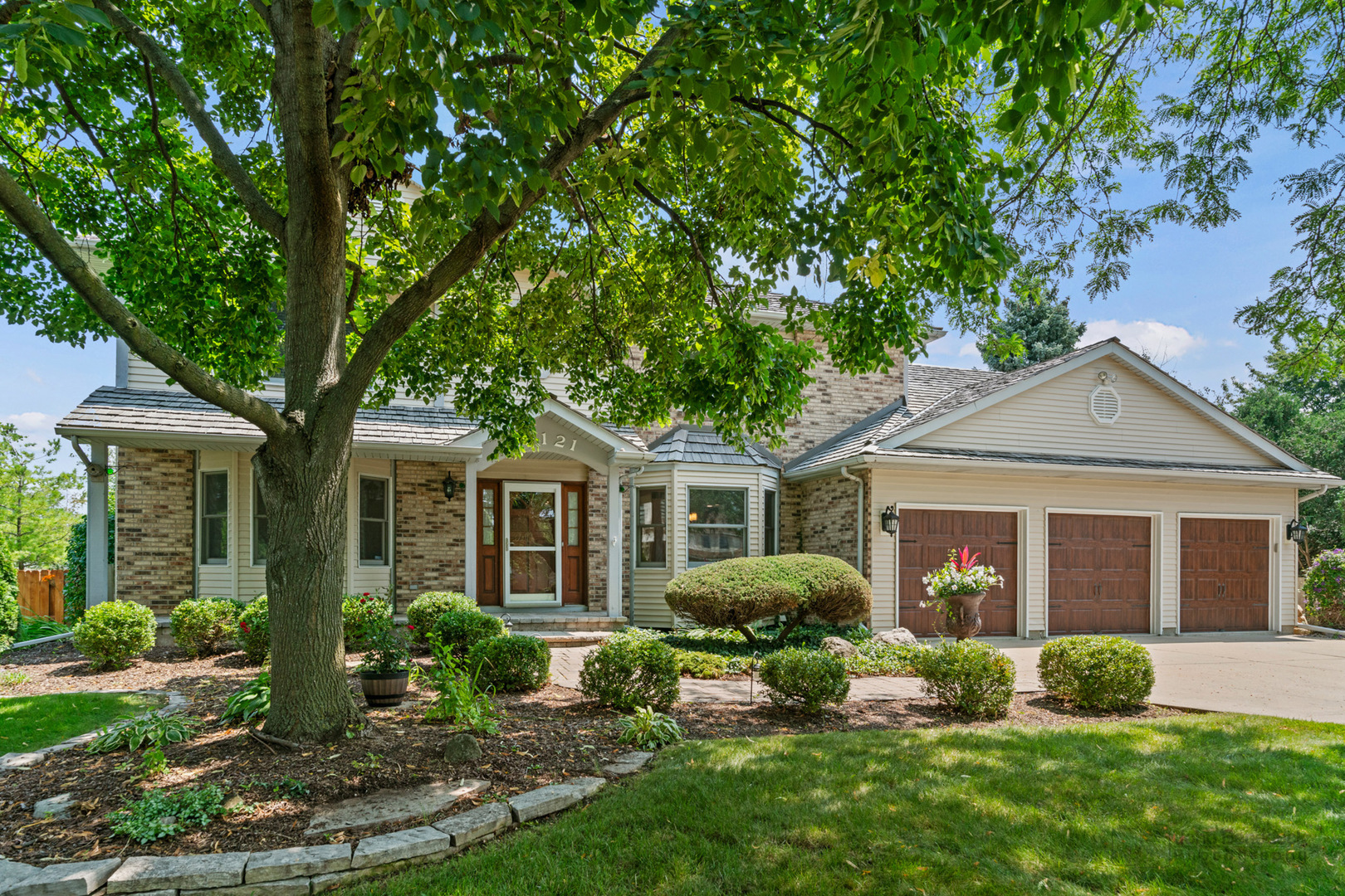 a front view of a house with a yard and porch