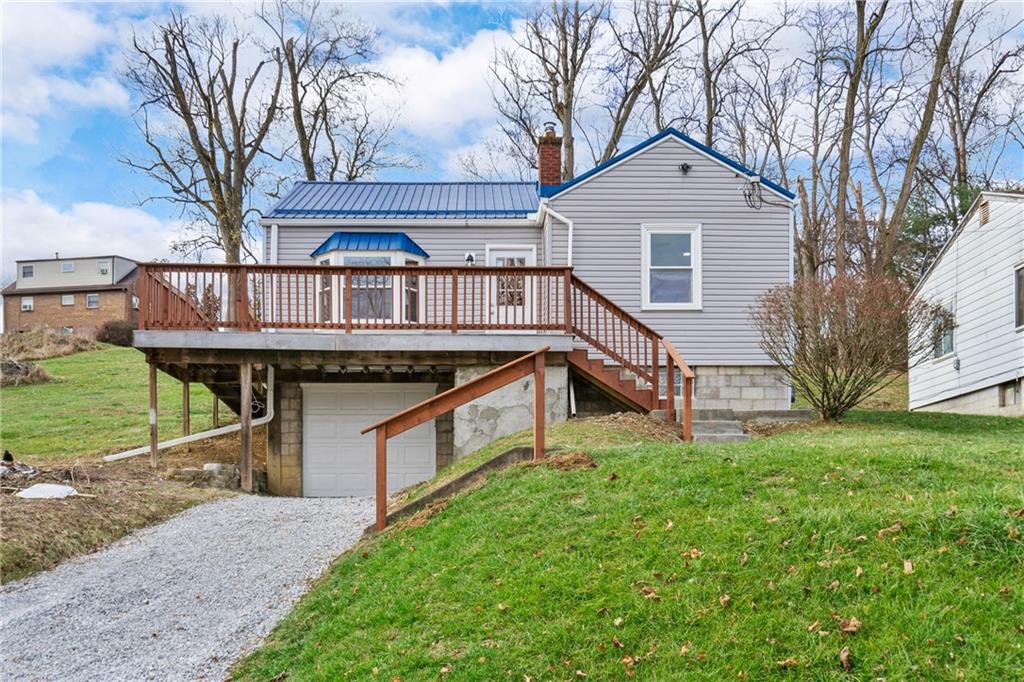 a front view of a house with yard and fence