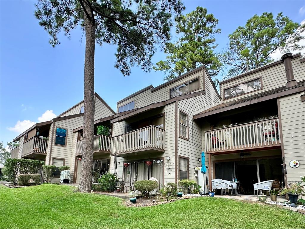 a view of an house with backyard space and balcony