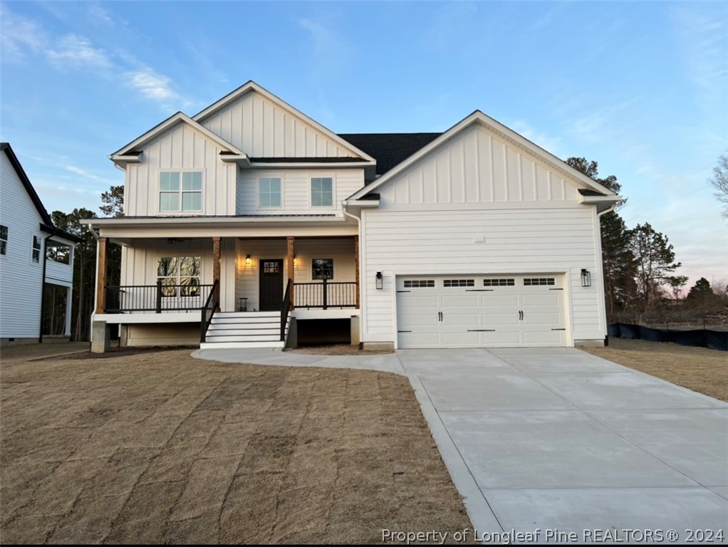 a view of house with outdoor space and parking