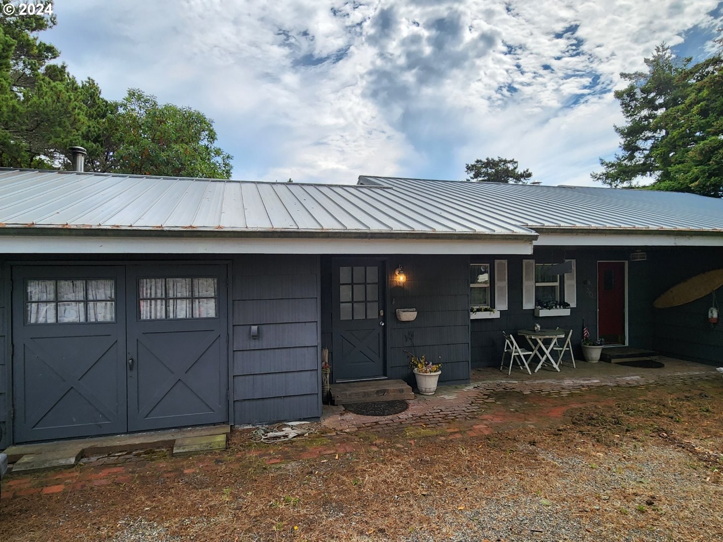 a view of a house with a patio and wooden fence