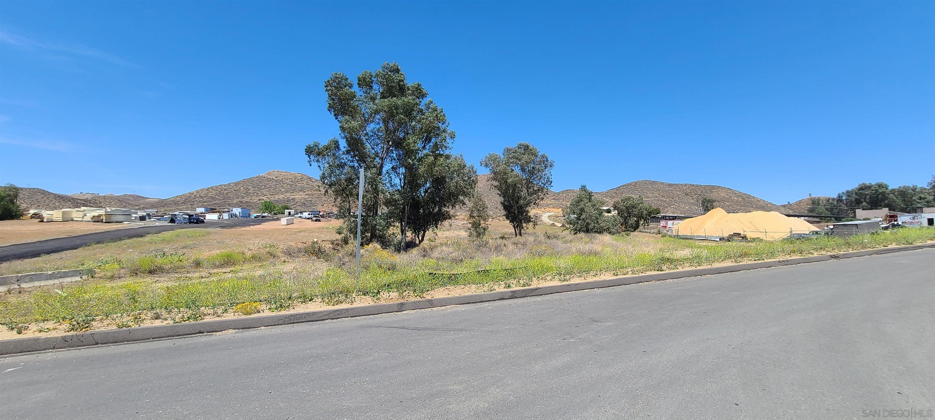 a view of a house with a yard and street