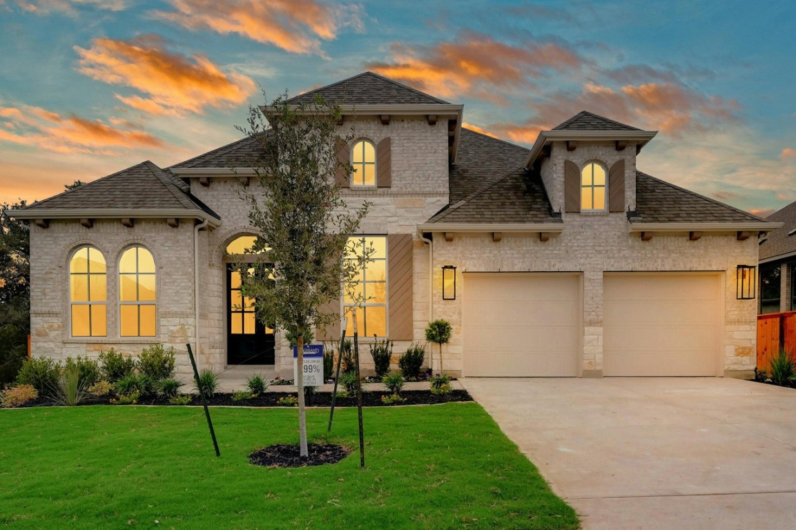 a front view of a house with a garden and plants