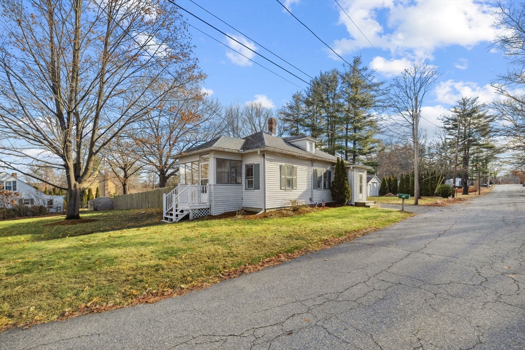 a yellow house sitting in middle of a yard