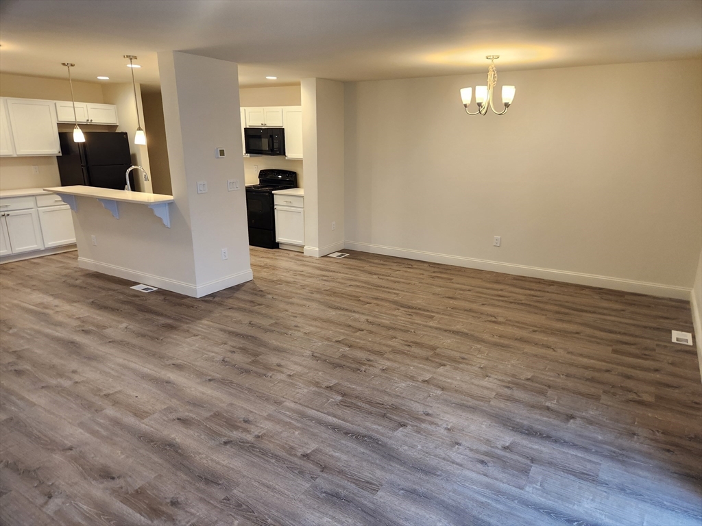 a view of a livingroom with furniture and wooden floor