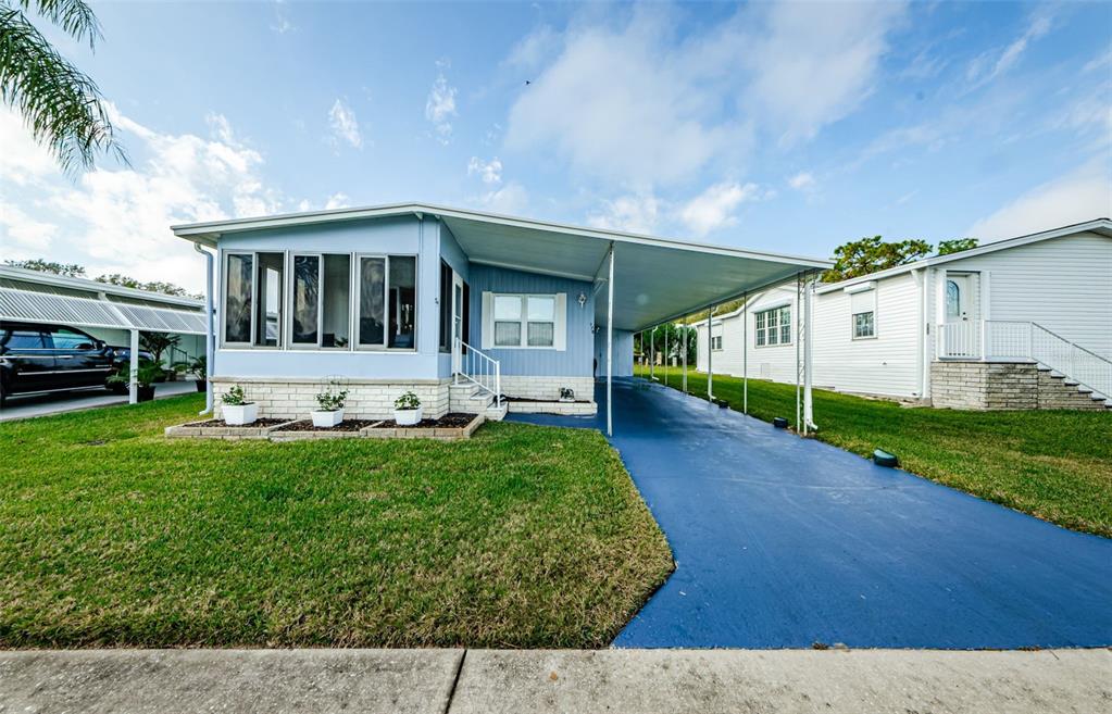 a front view of a house with a yard and porch