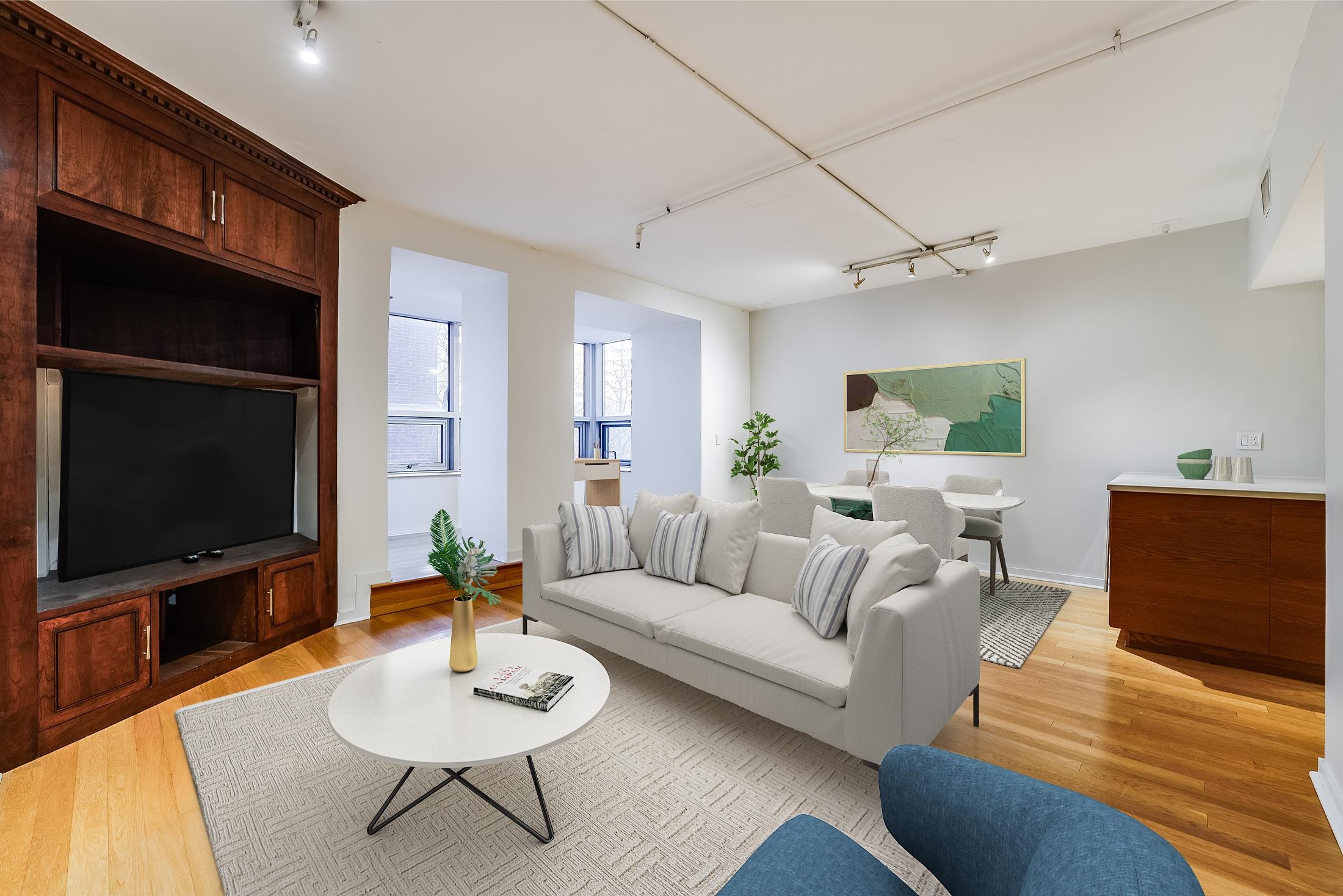 a living room with furniture a rug and a flat screen tv