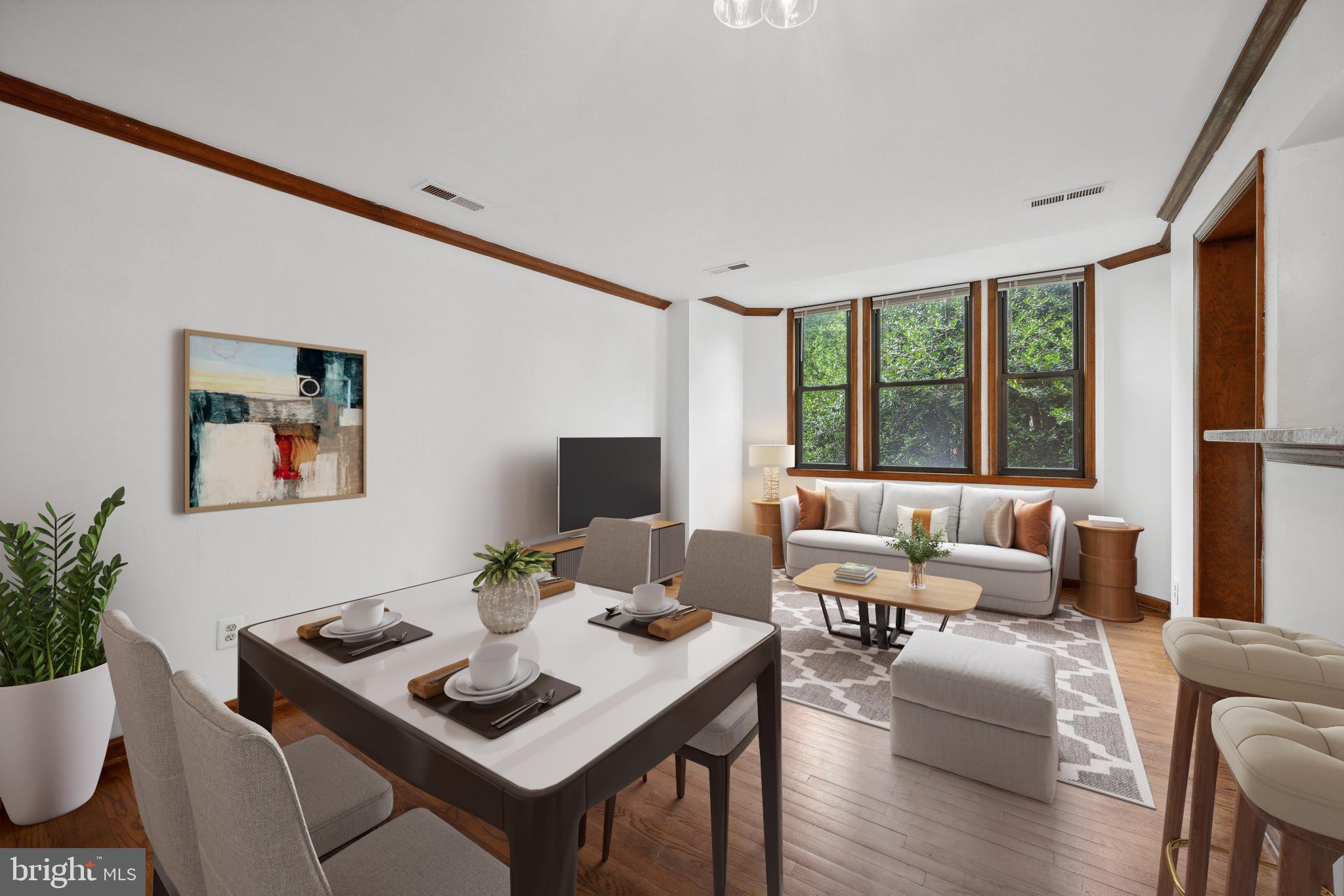 a view of a dining room with furniture large windows and wooden floor