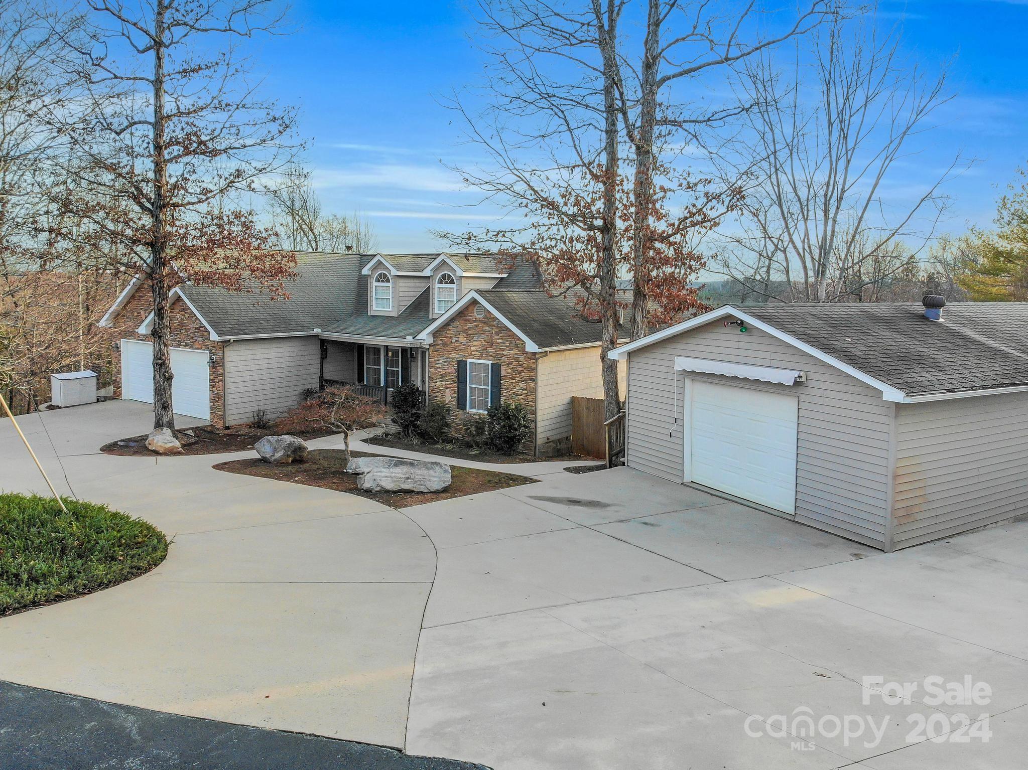 a front view of a house with yard garage and outdoor seating