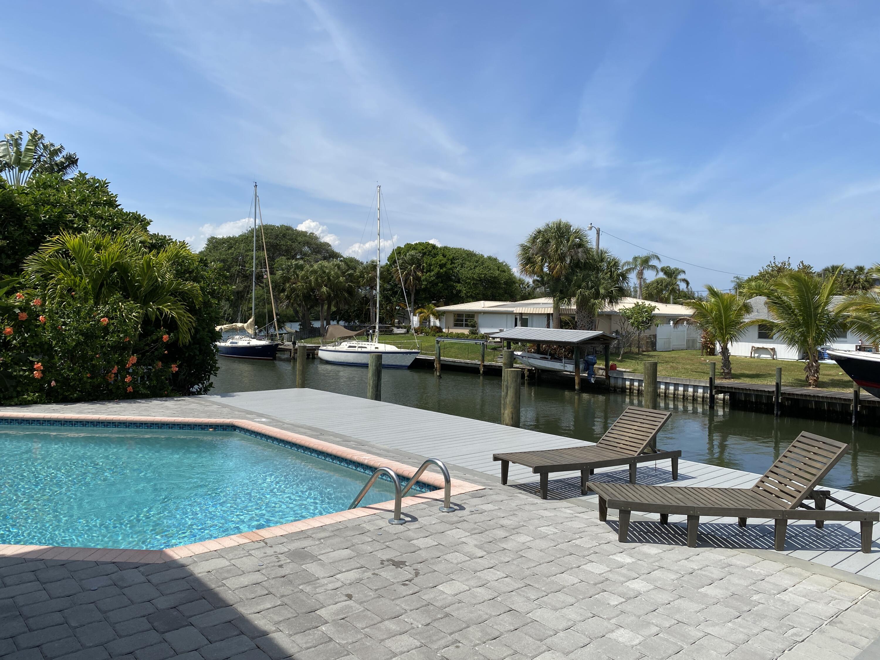 a swimming pool with outdoor seating and yard