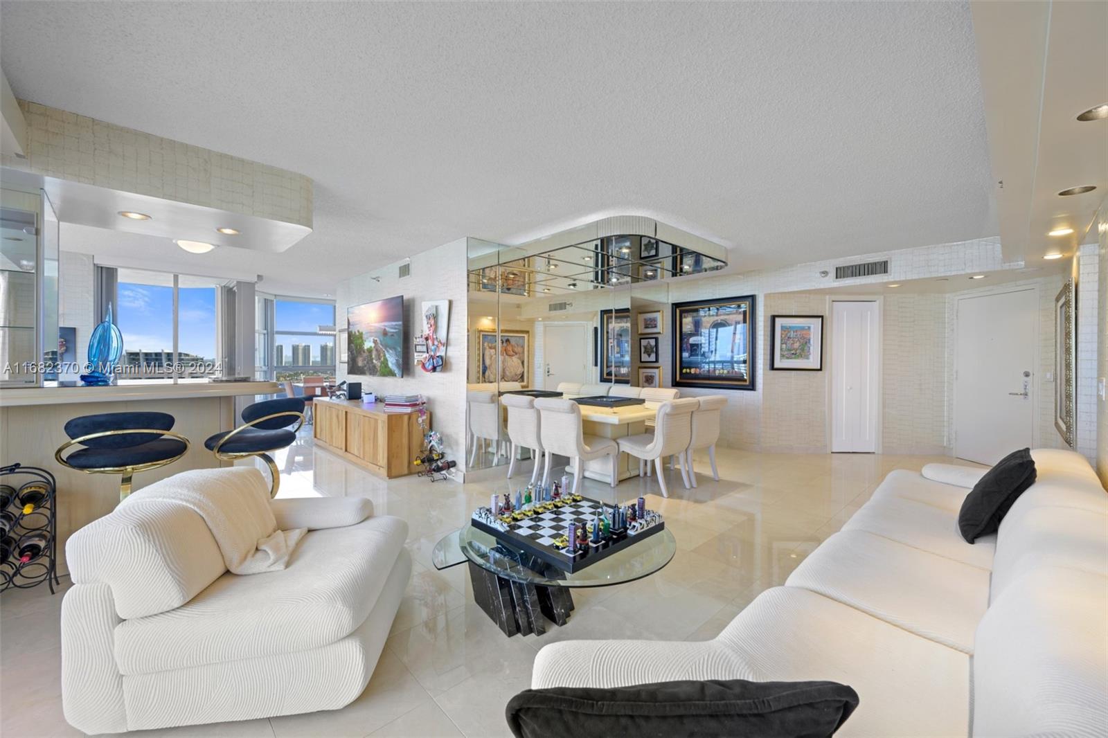 a living room with furniture and view of kitchen