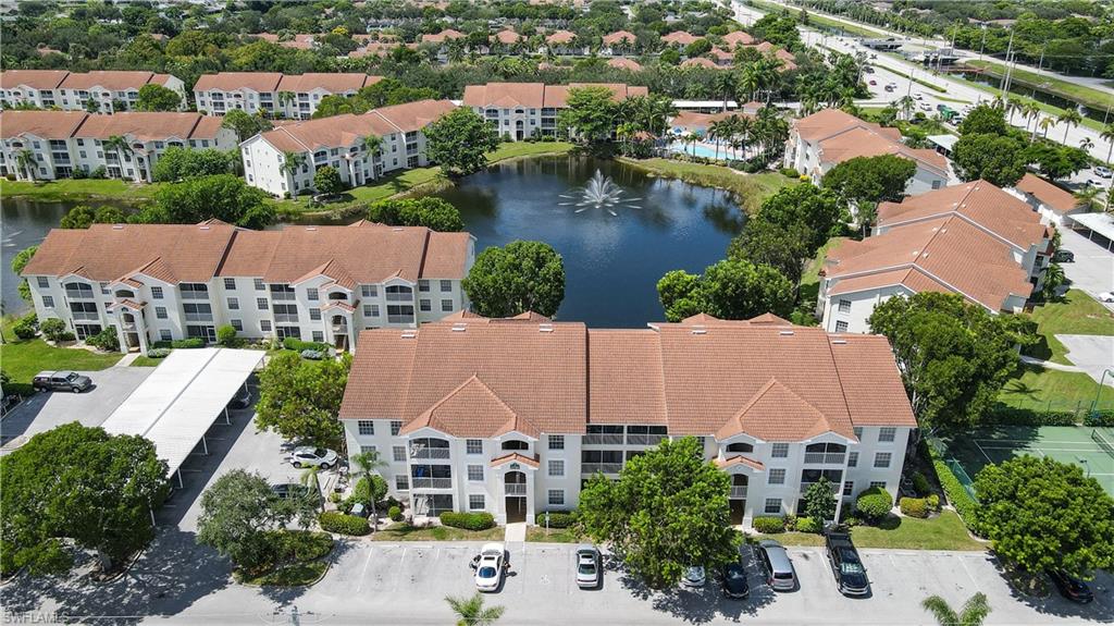 Birds eye view of property with a water view