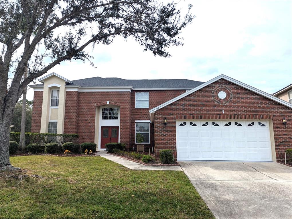 a front view of a house with a yard and garage