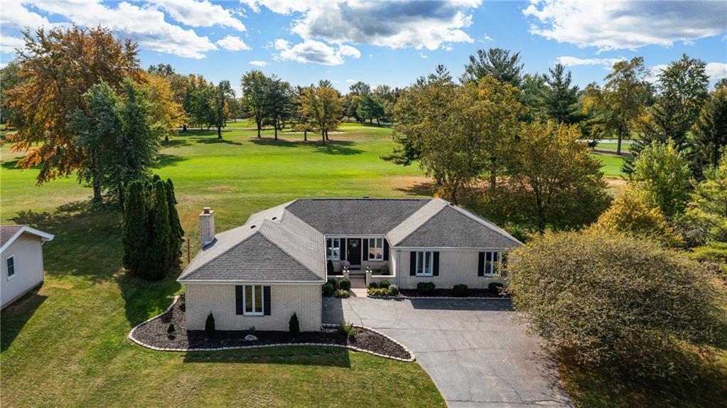 a aerial view of a house with swimming pool and garden