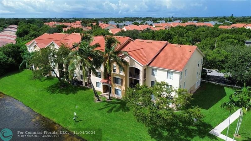 an aerial view of a house with a garden and swimming pool