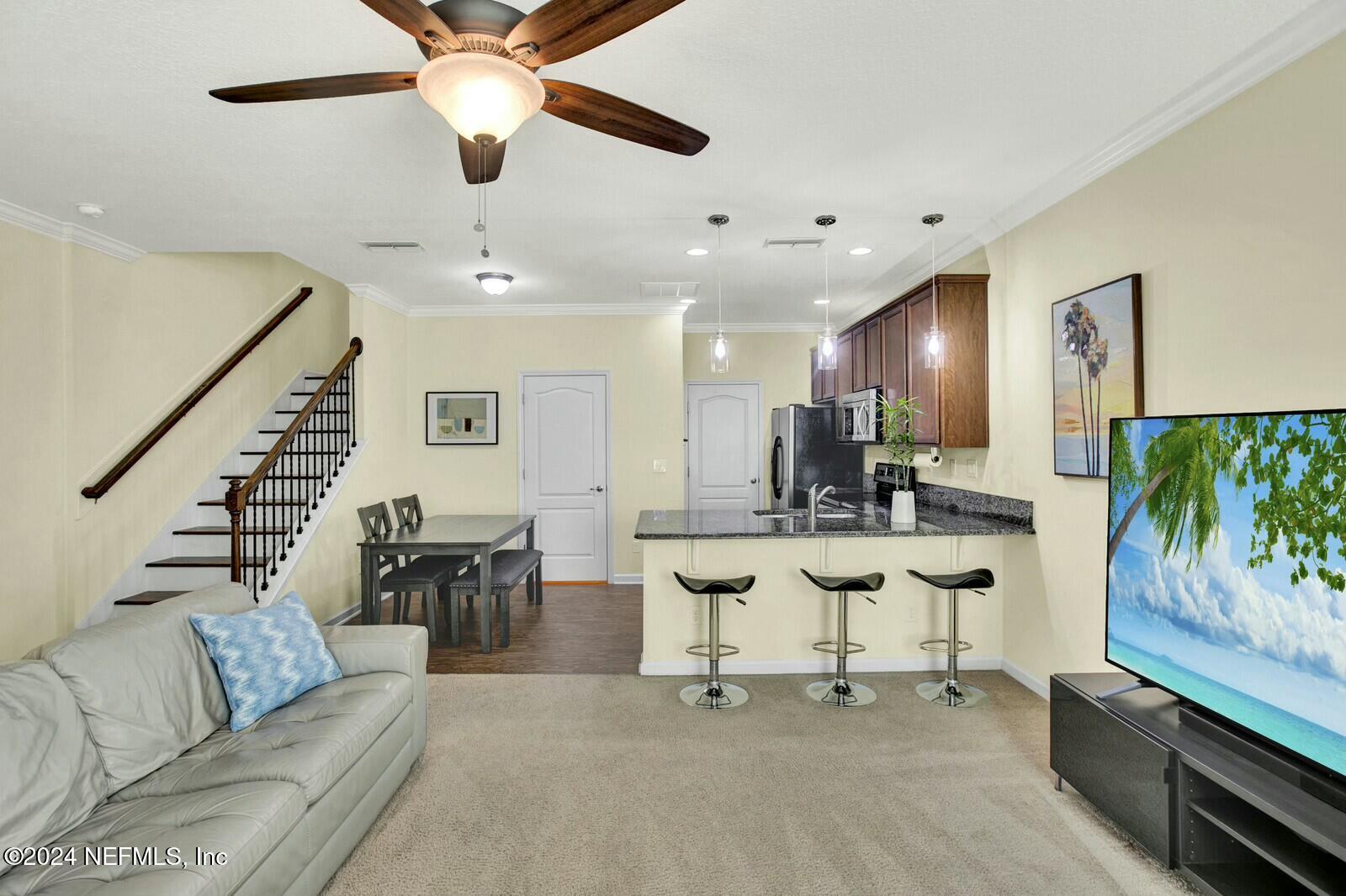 a living room with furniture and a flat screen tv