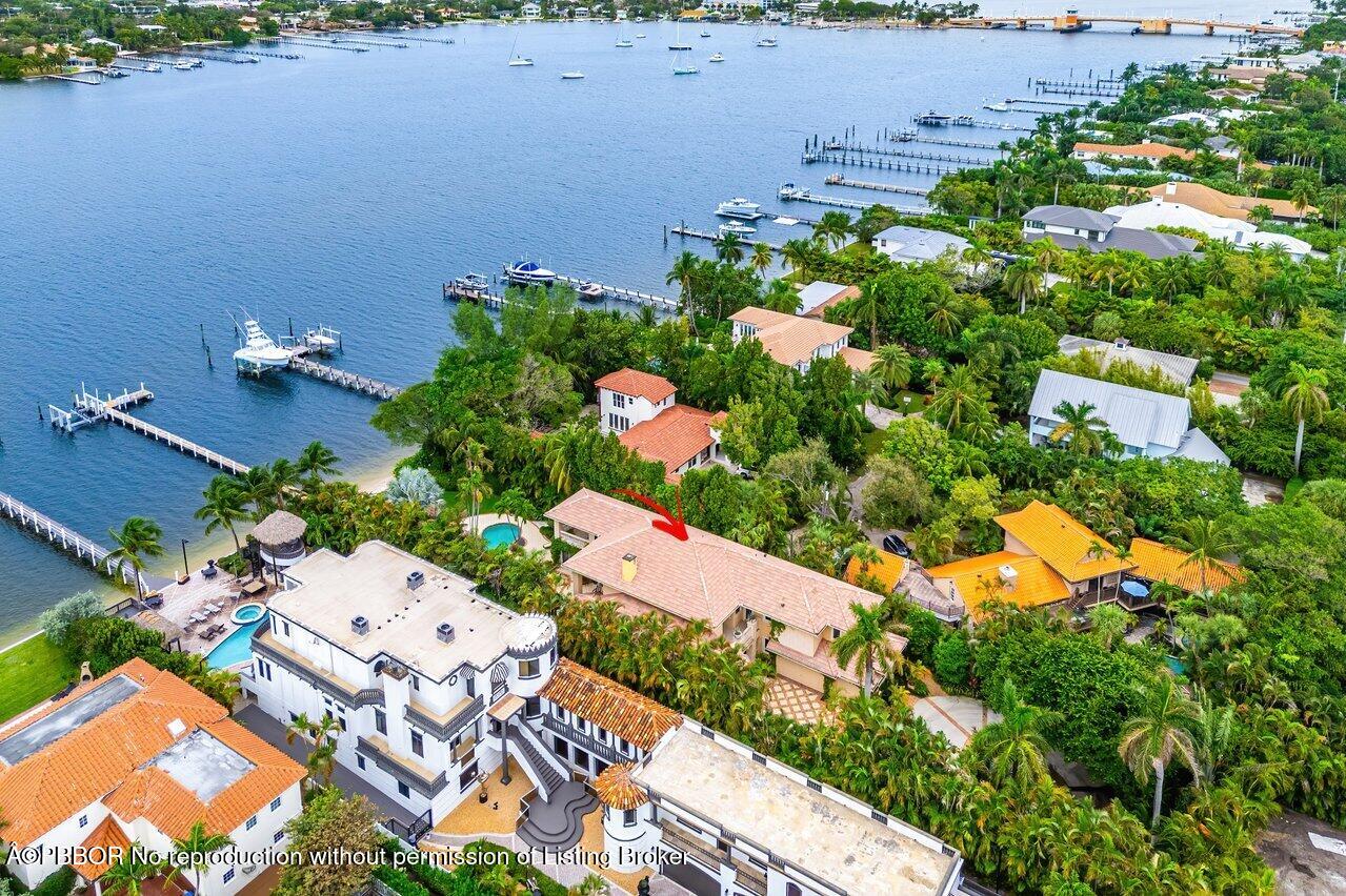 an aerial view of a house with a yard and lake view