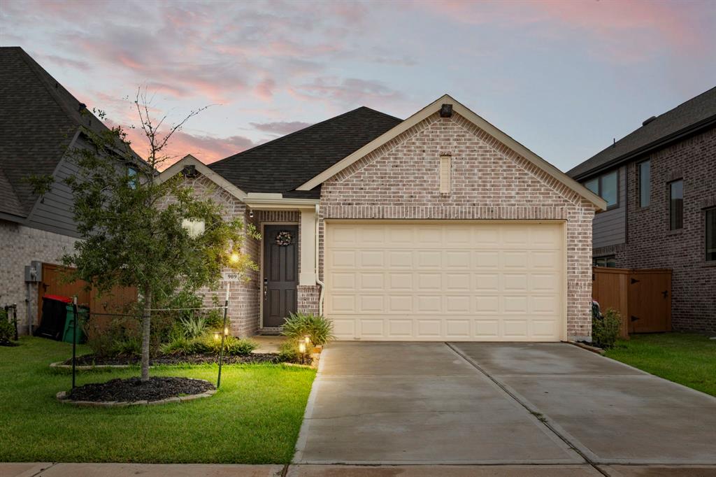 a front view of house with yard and garage