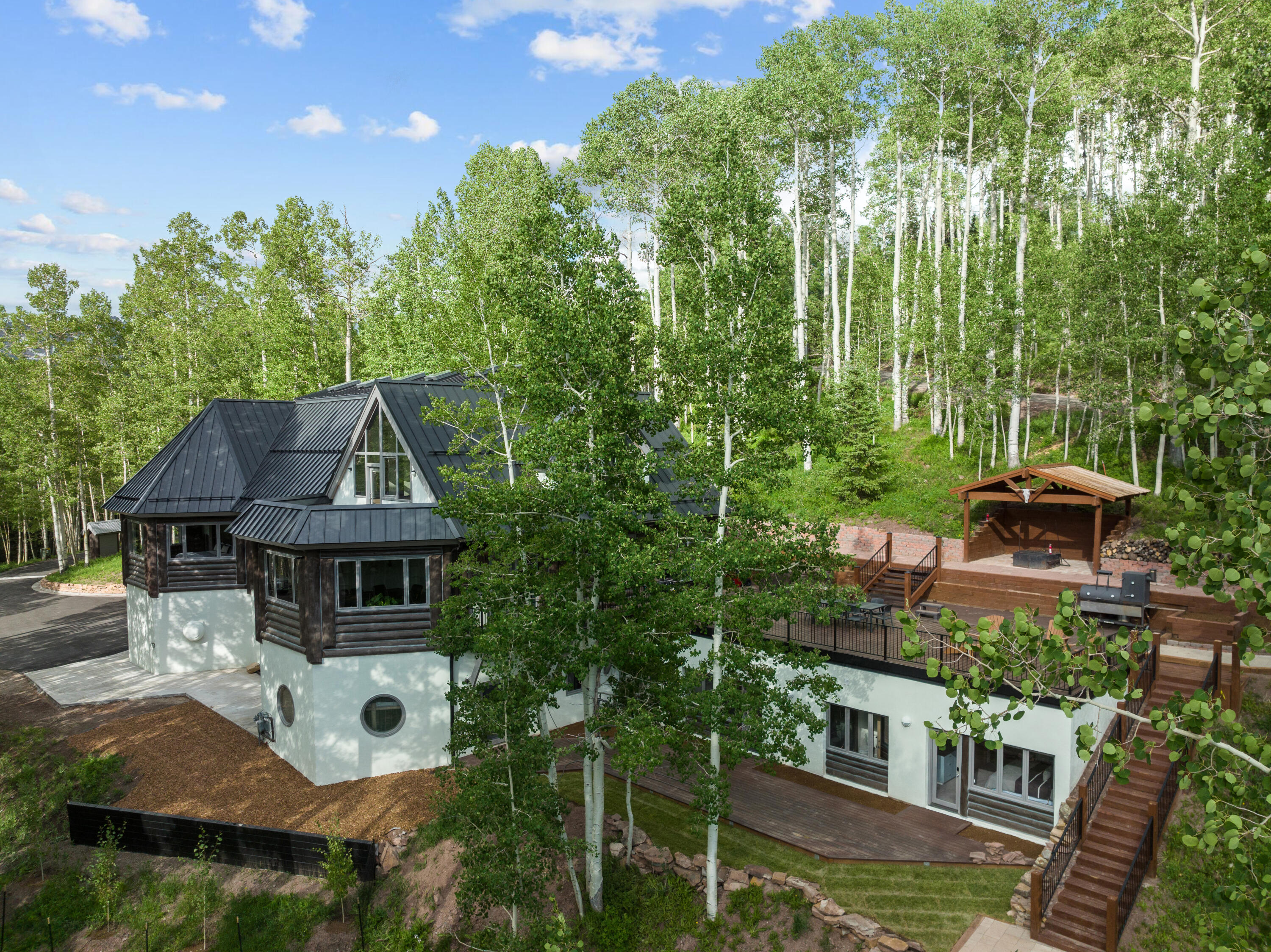 a aerial view of a house with swimming pool garden view and trees