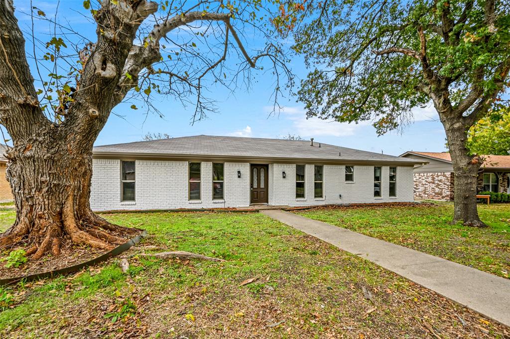 Single story home featuring a front lawn