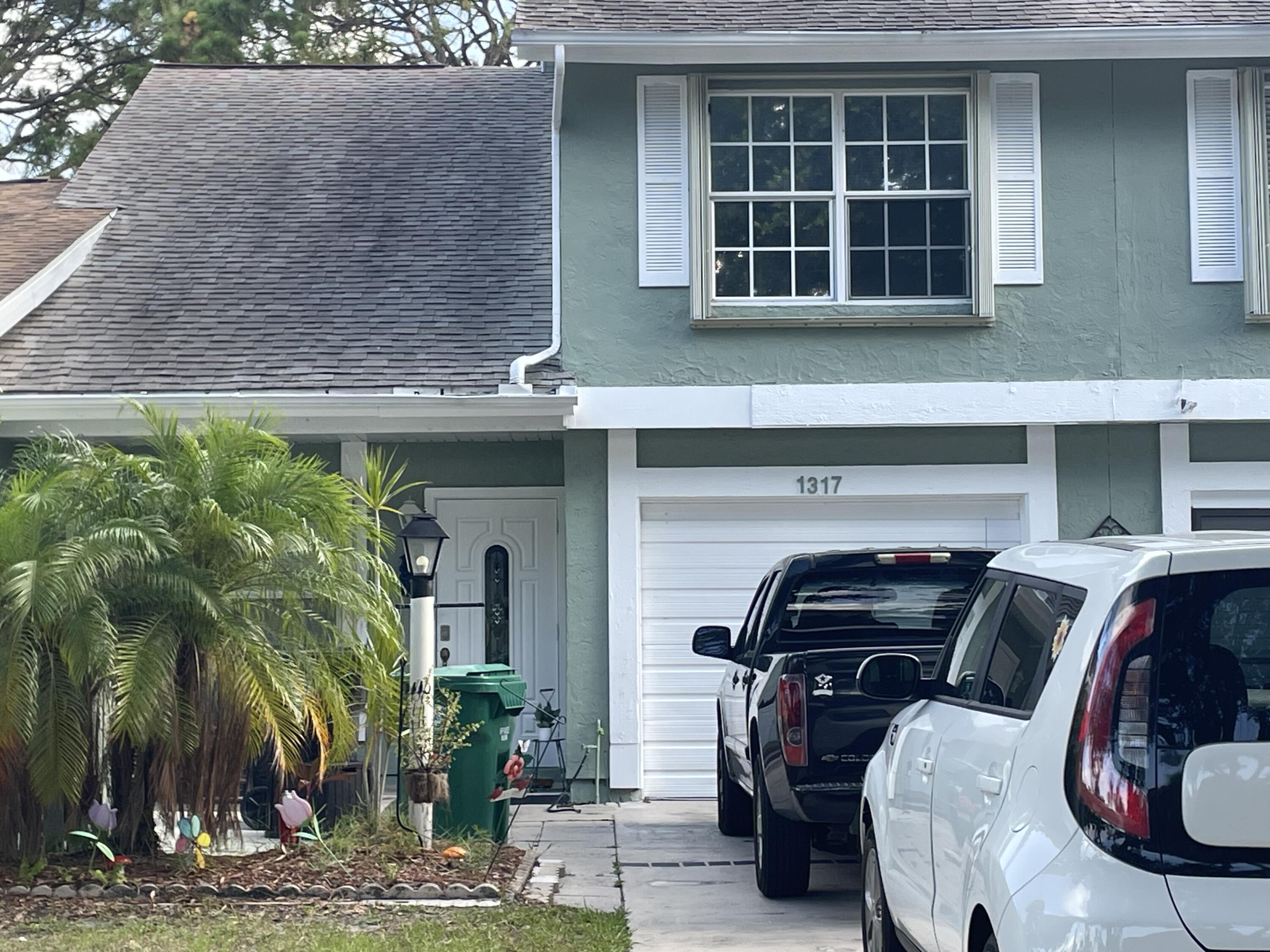 a view of front door and car parked