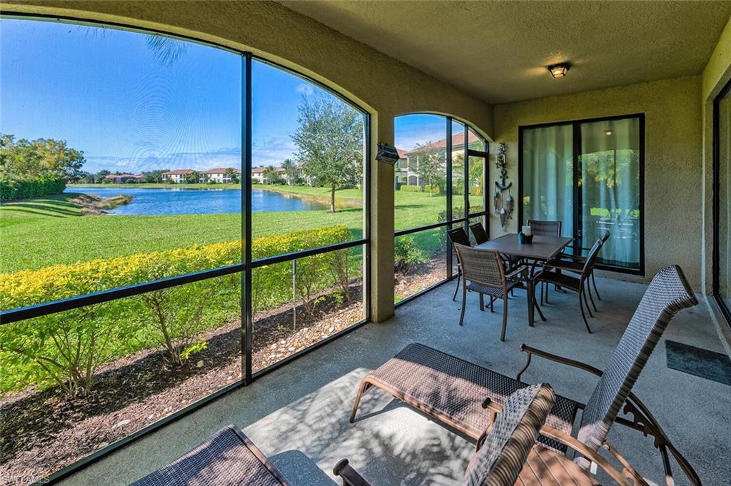 a view of a living room and floor to ceiling window and an outdoor seating