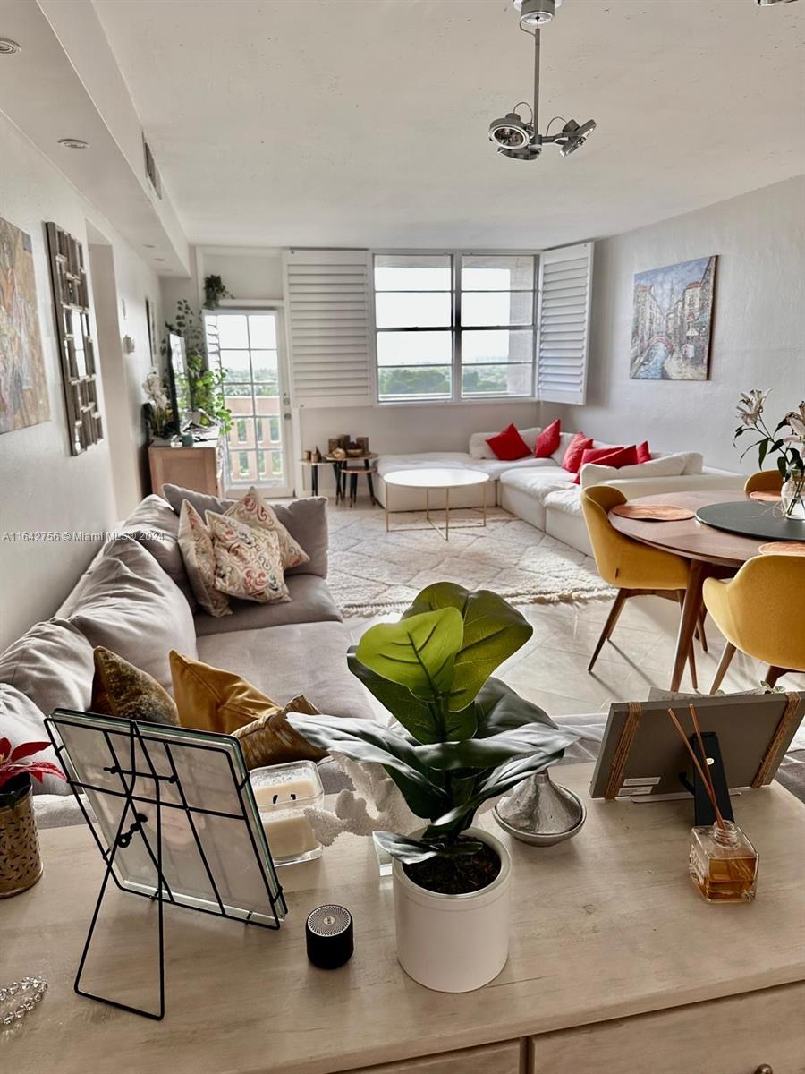 a living room with furniture a rug and a large window