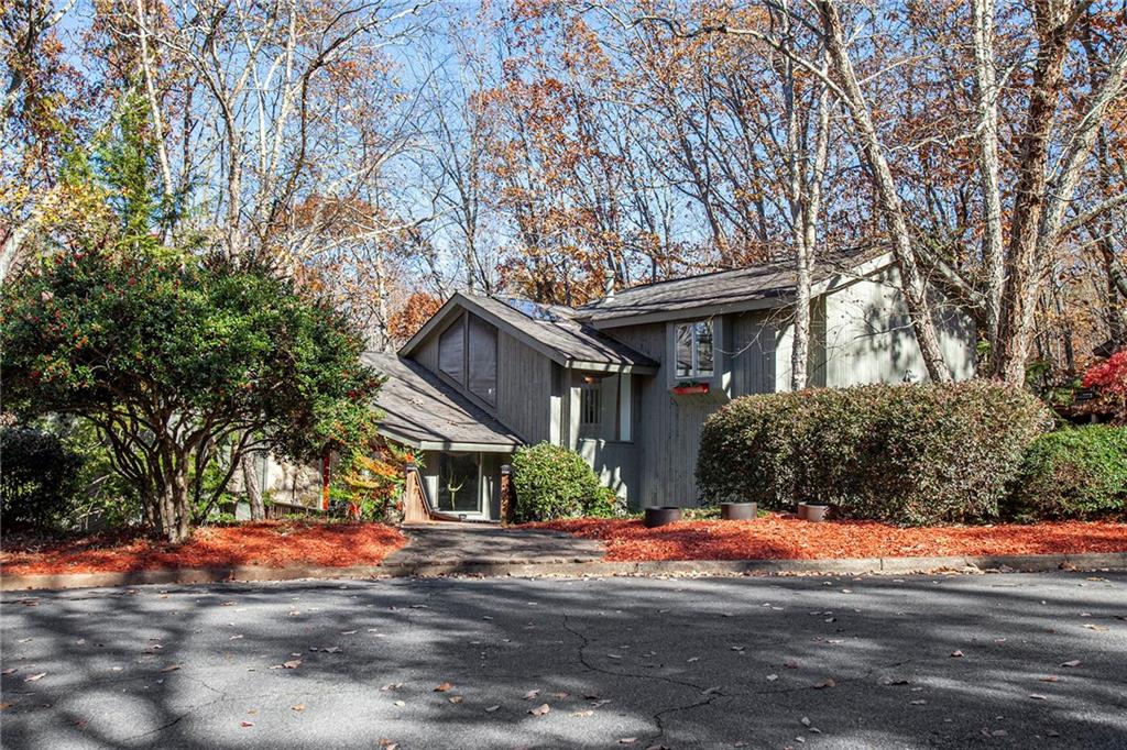 a front view of a house with yard and trees