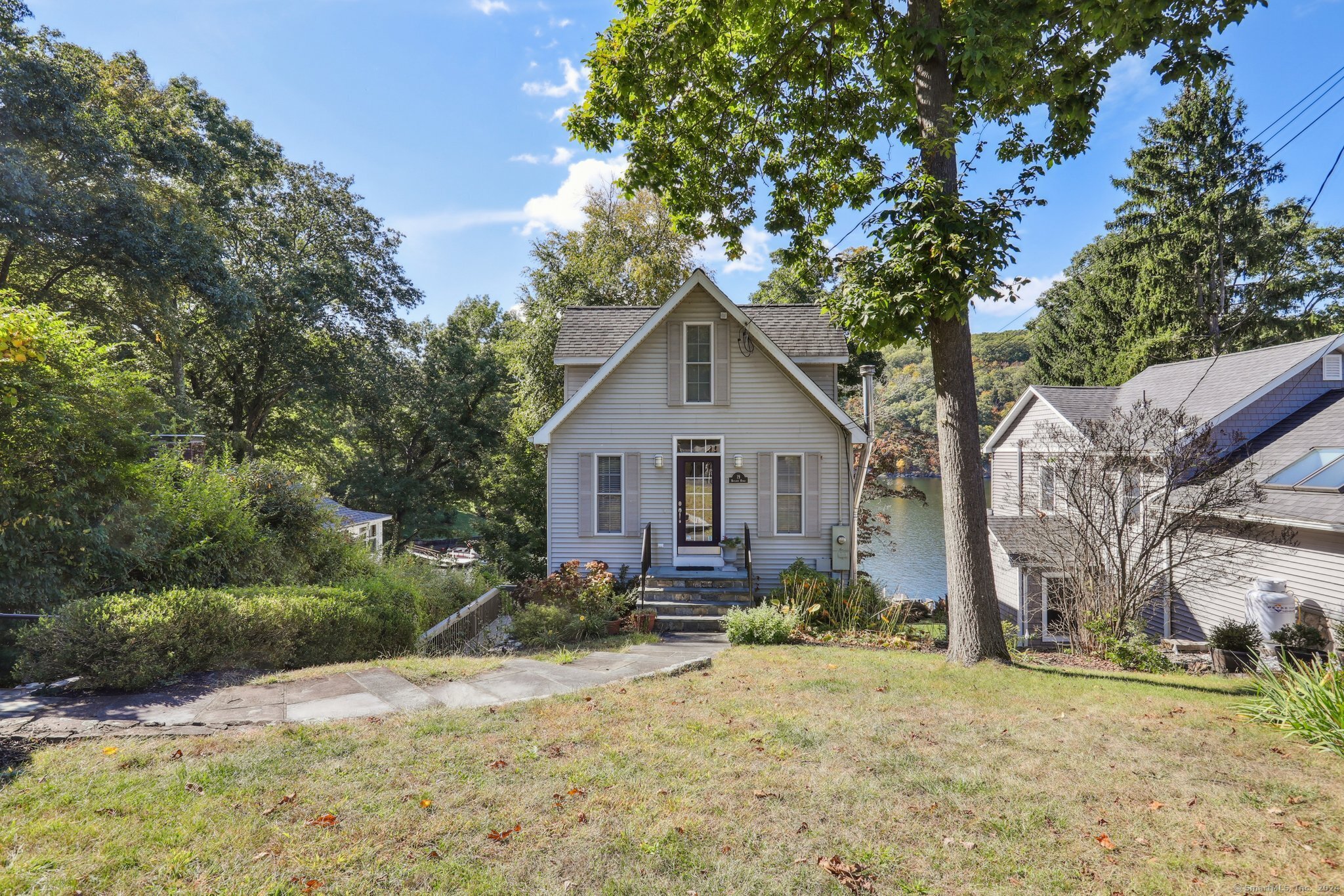 a front view of house with yard and trees around