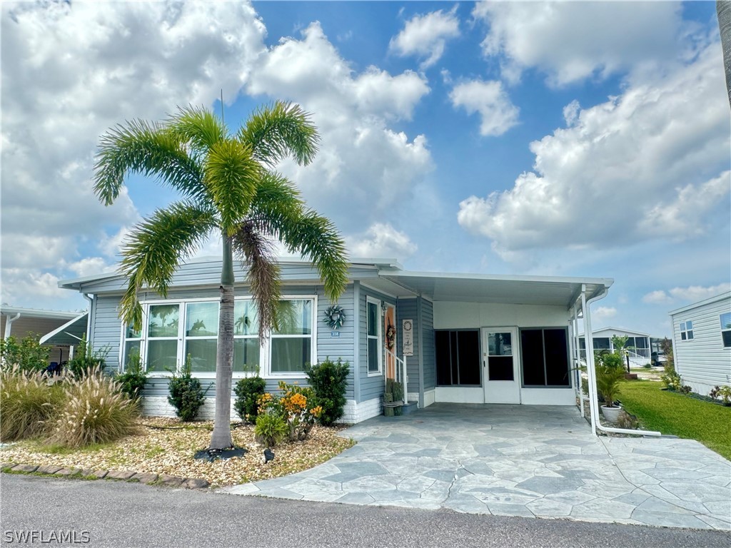 a front view of a house with garden and plants