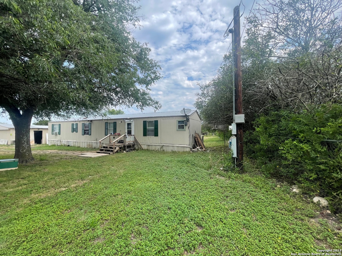 a front view of house with yard and trees