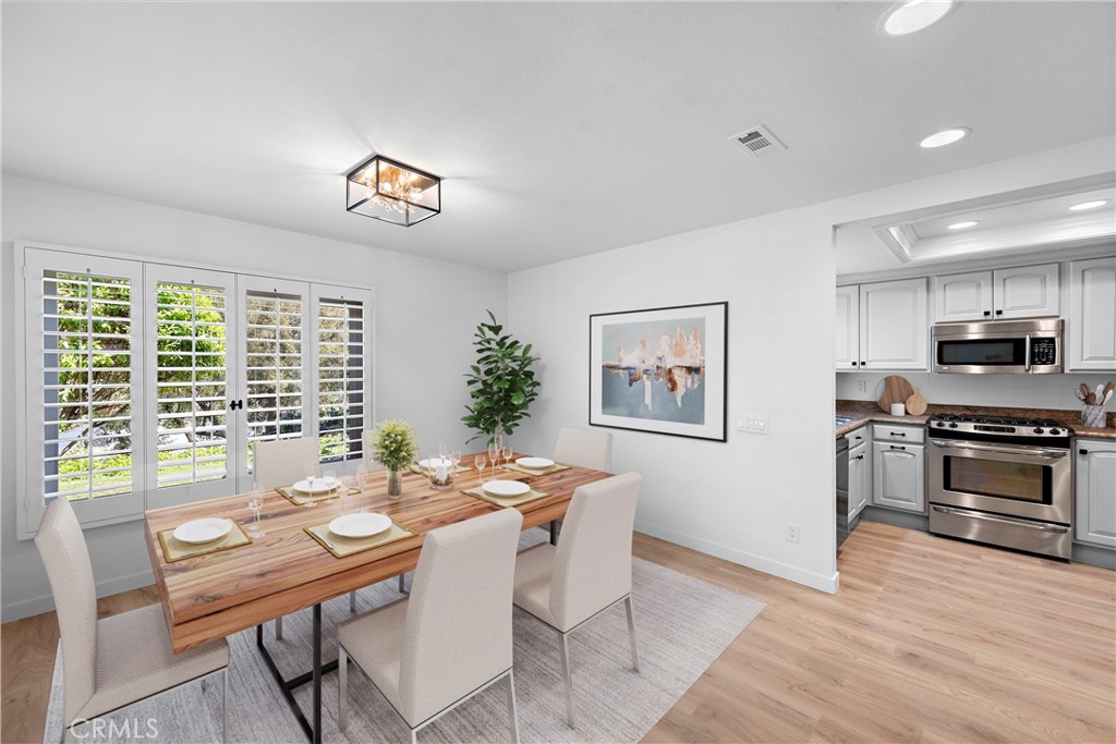 a view of a dining room with furniture window and wooden floor