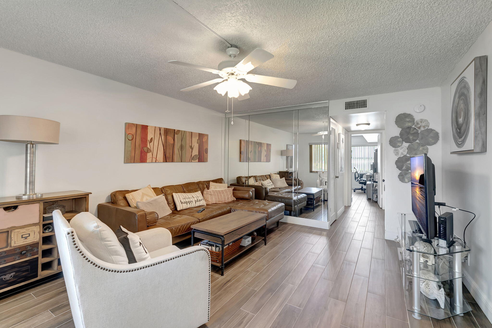 a living room with furniture and a wooden floor