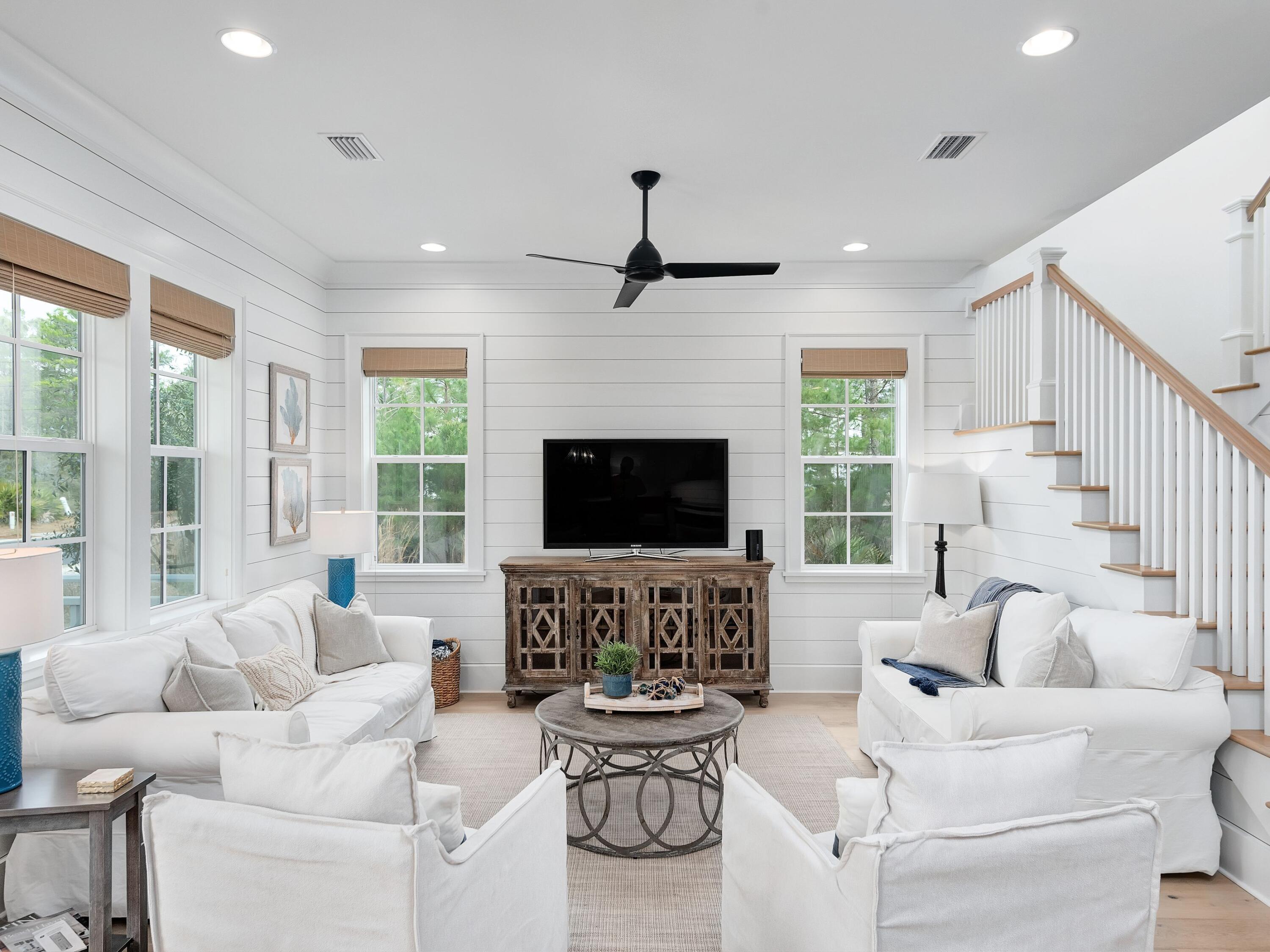 a living room with furniture a large window and a fireplace