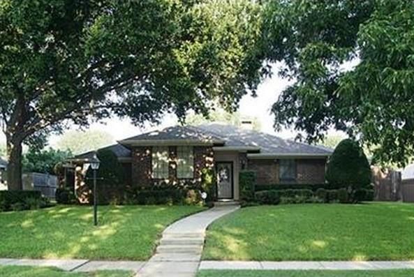 a front view of house with a garden