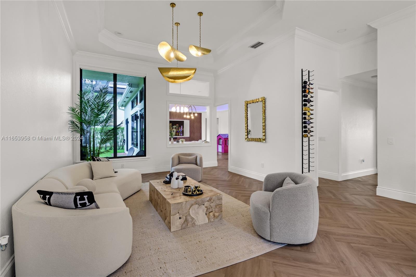 a living room with furniture and a chandelier