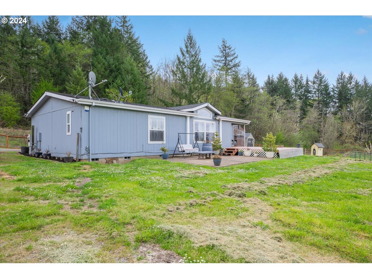 a view of house with backyard and outdoor seating