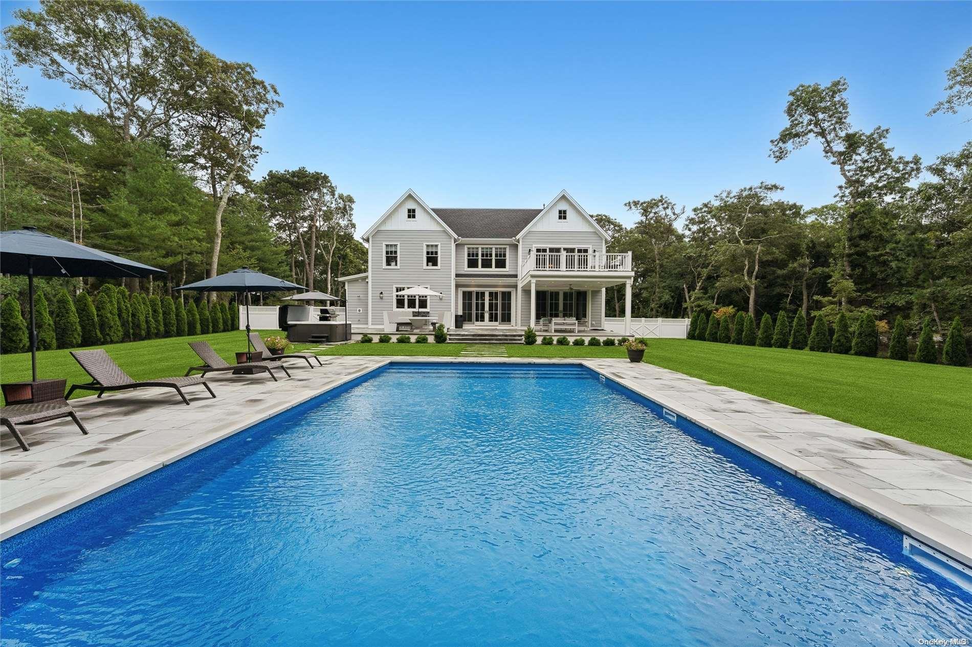 a view of a house with swimming pool and sitting area