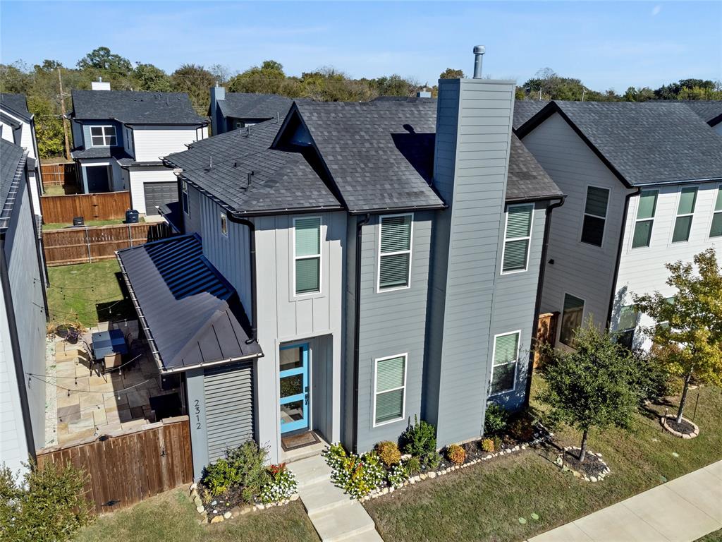 aerial view of a house with a yard and potted plants