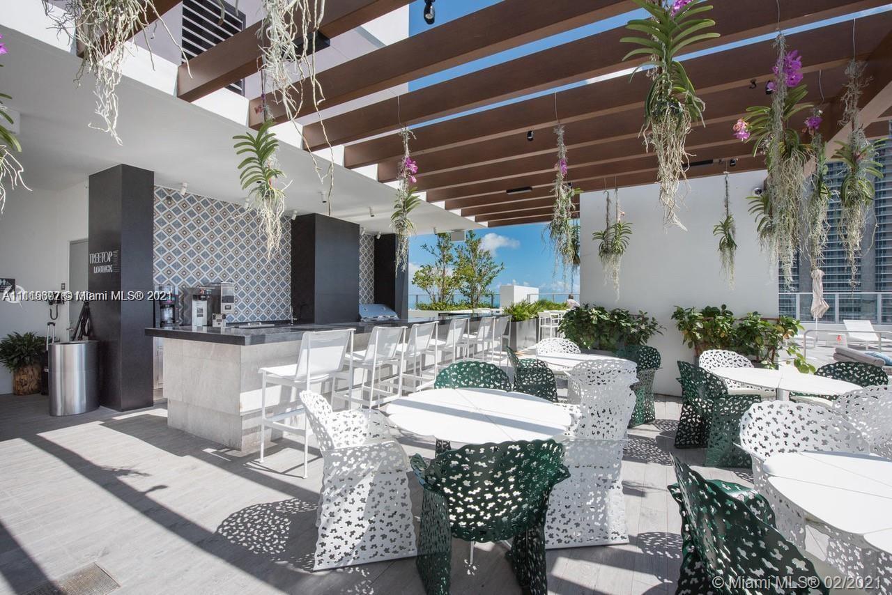 a view of a patio with couches table and chairs and potted plants