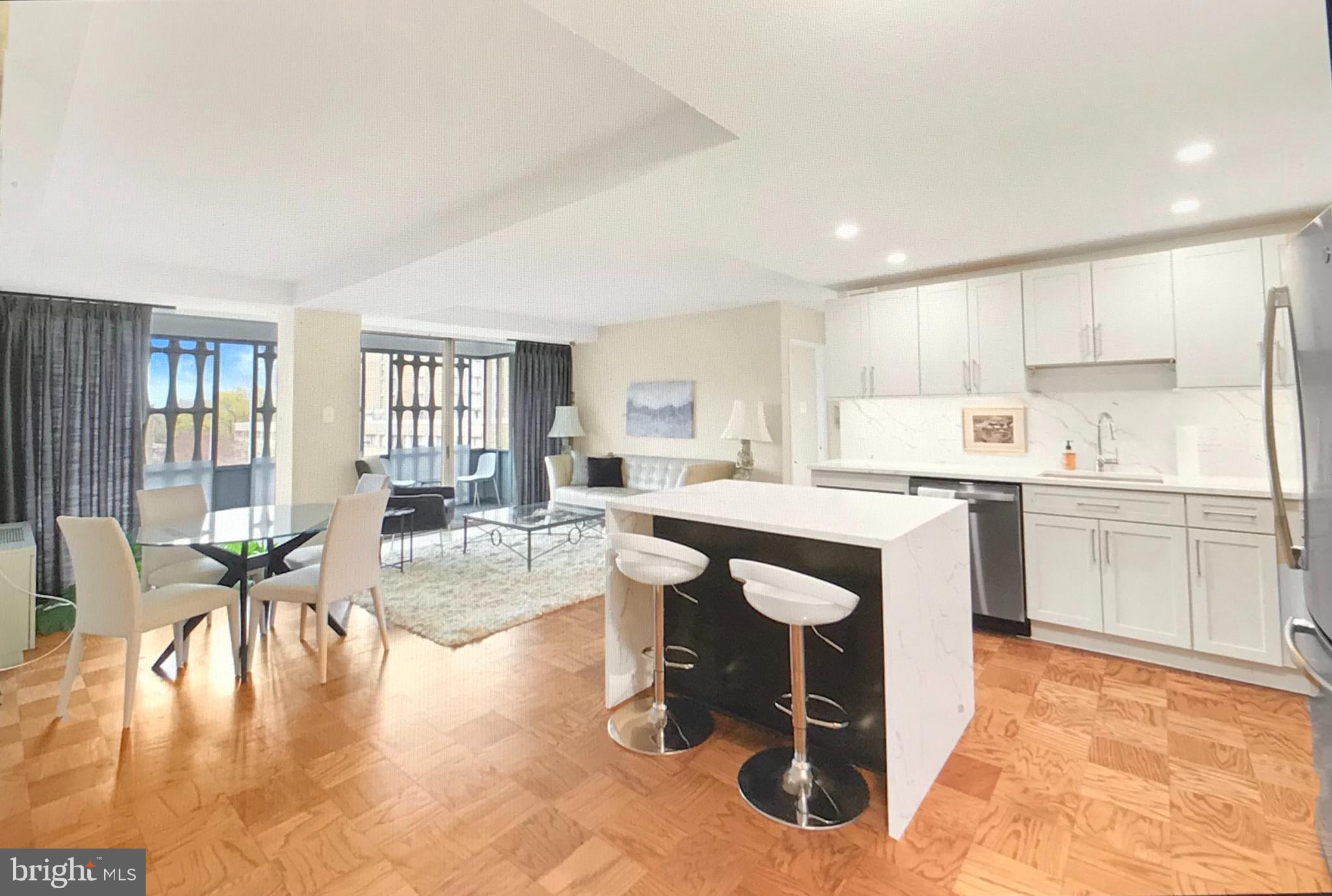 a kitchen with a table chairs refrigerator and cabinets