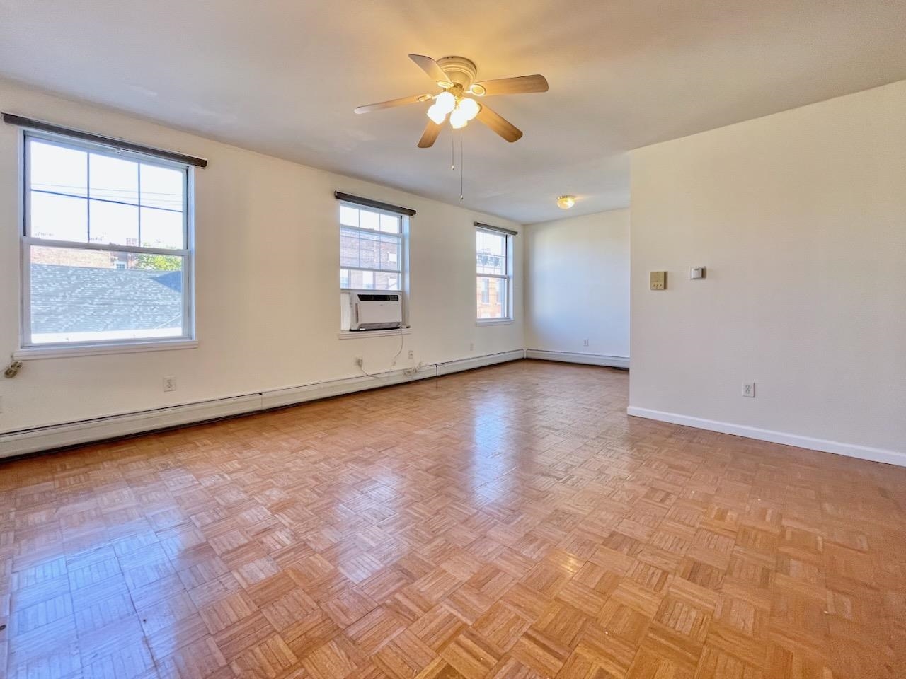 wooden floor in an empty room with a window