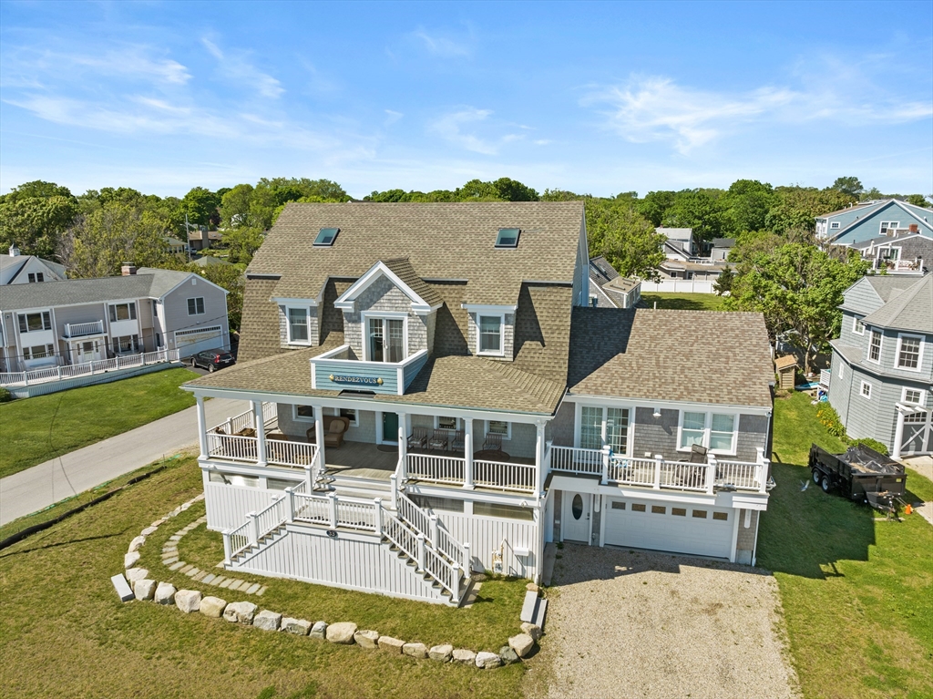 an aerial view of a house with swimming pool and mountains