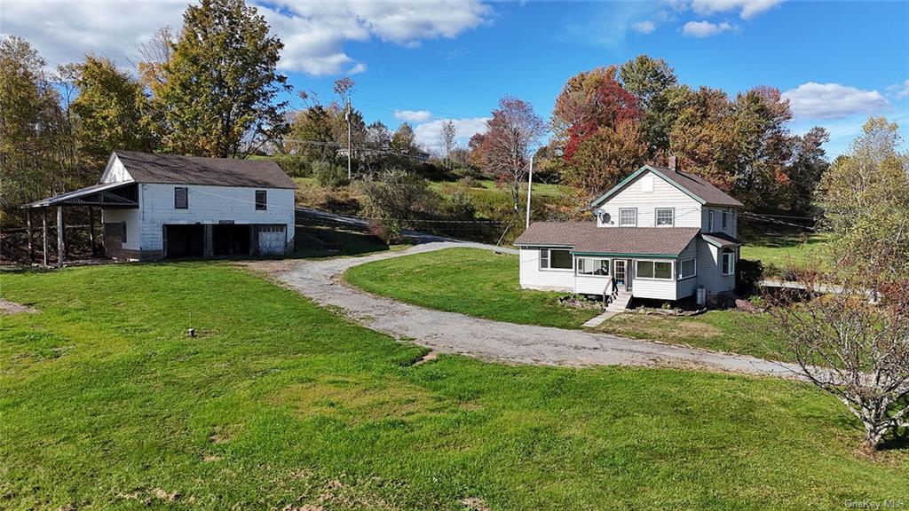 Back of house with outbuilding