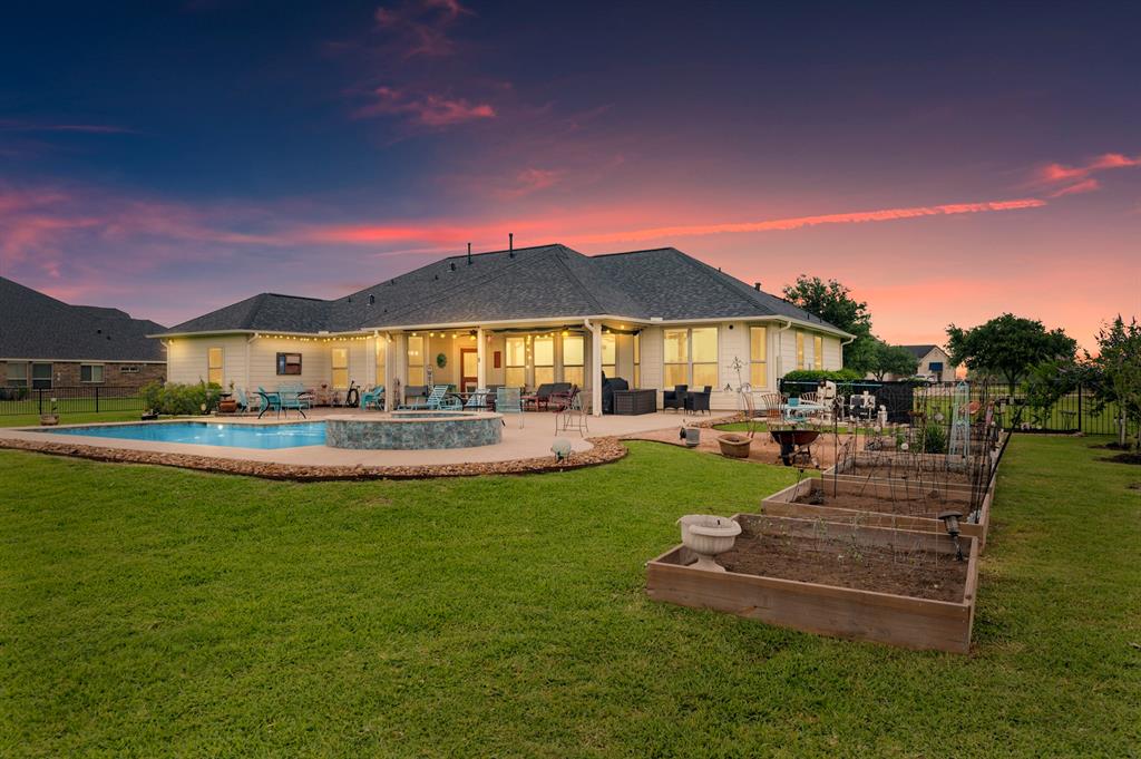 a view of a house with swimming pool and porch with a garden