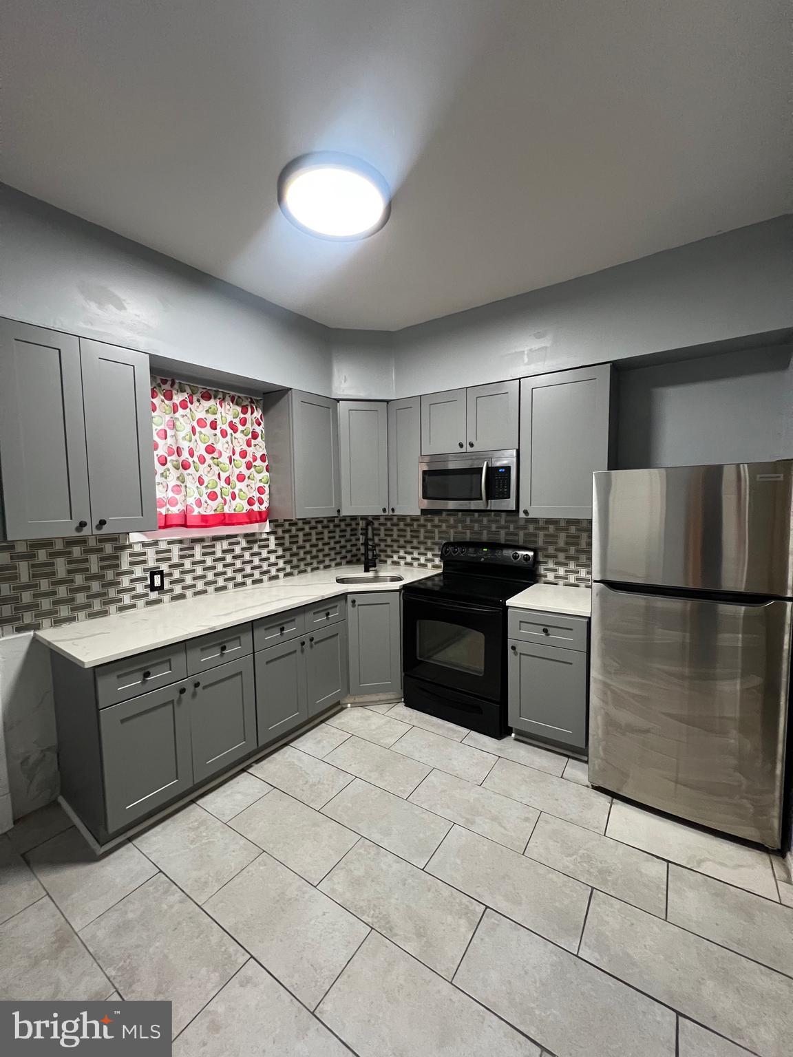 a kitchen with stainless steel appliances granite countertop a refrigerator sink and cabinets