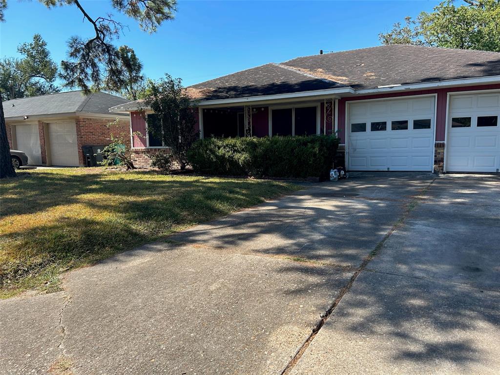 a front view of a house with a yard and potted plants